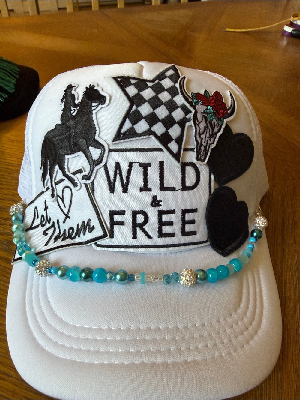 White 'Wild & Free' Patch Trucker Hat with Turquoise Beaded Accent